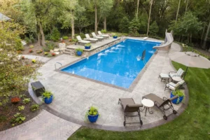 backyard concrete pool deck with chairs in Spring Hill, Florida